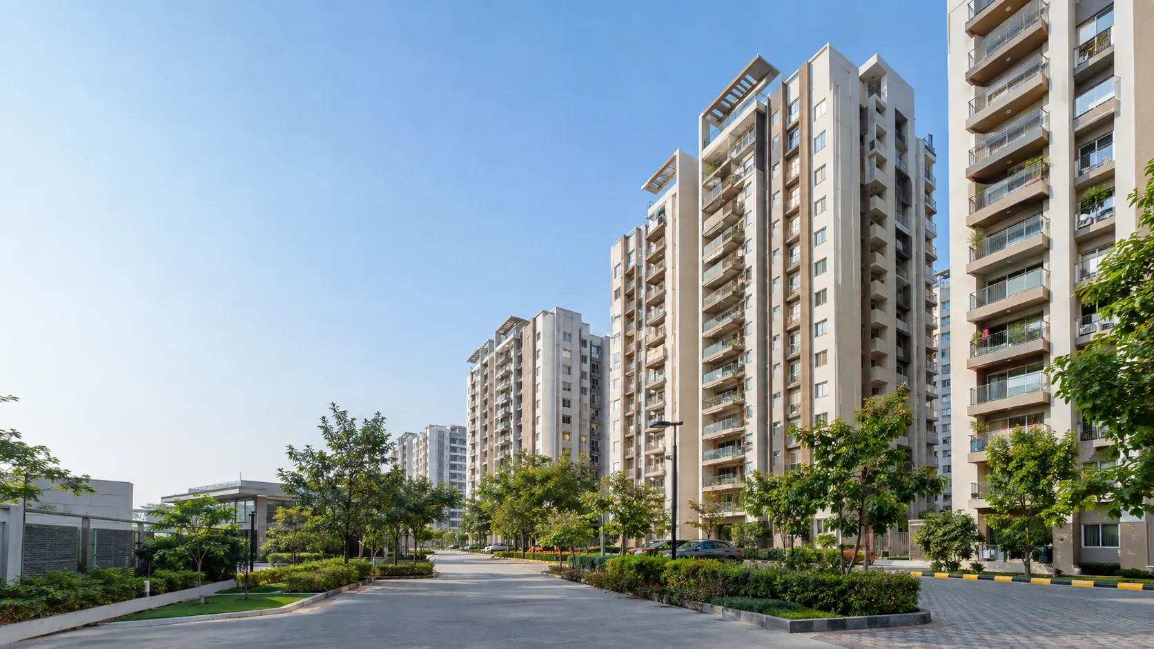 Gated community apartment towers with landscaped internal roads in Manikonda Hyderabad
