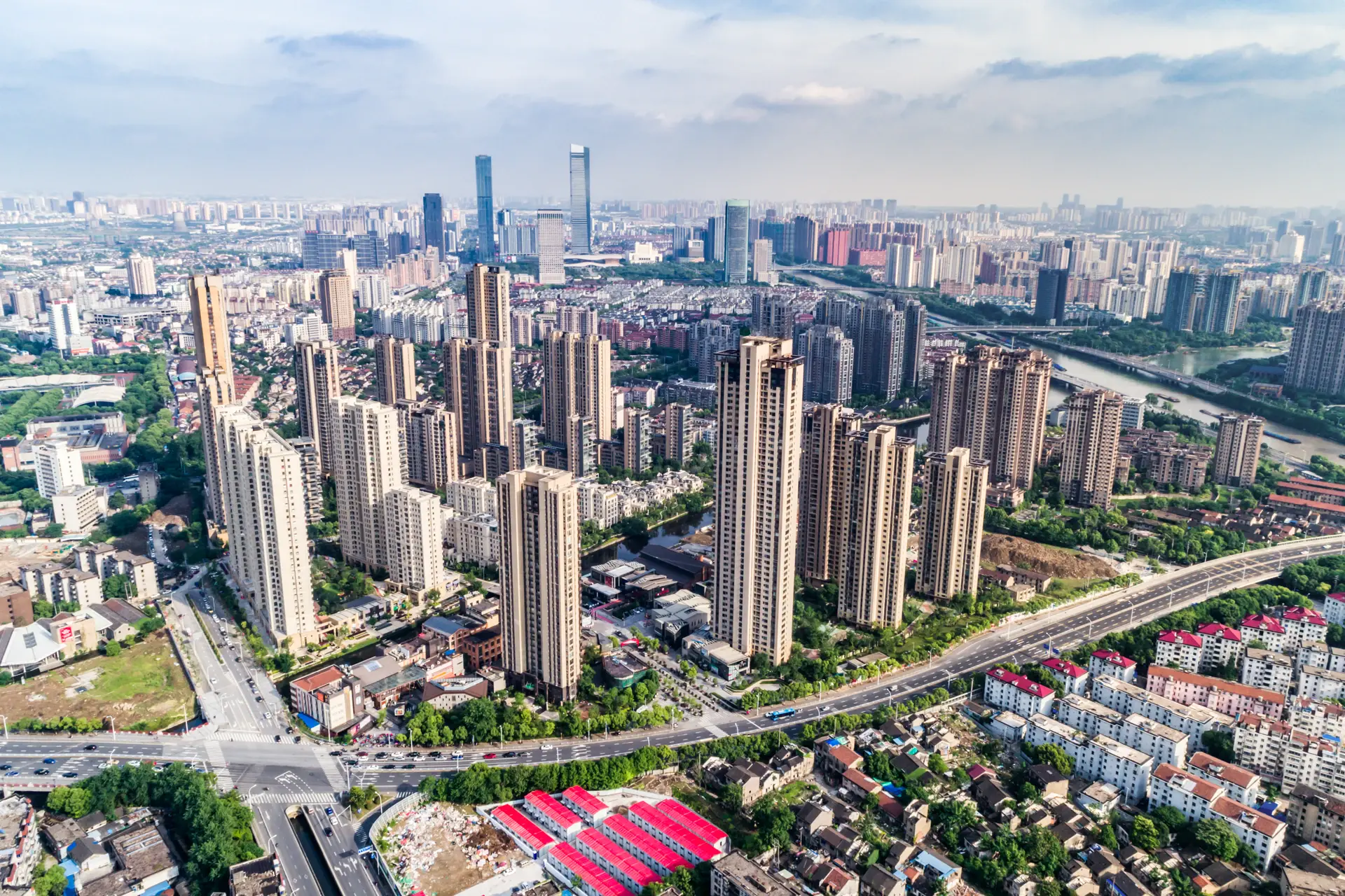 Aerial view of tall residential apartment towers against a clear blue sky